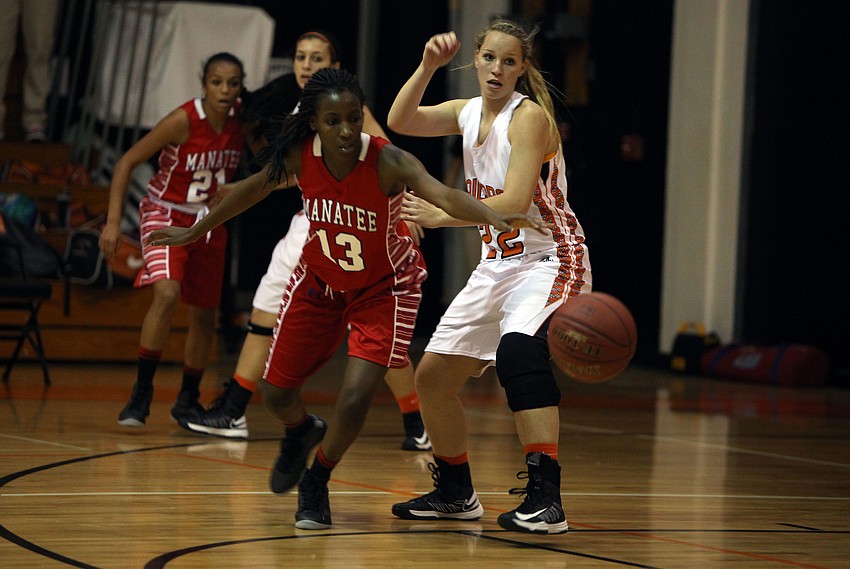 Manatee's Whitney Davis, No. 13, and Sarasota's Caylee Wallace, No. 22, try to beat one another to the ball.