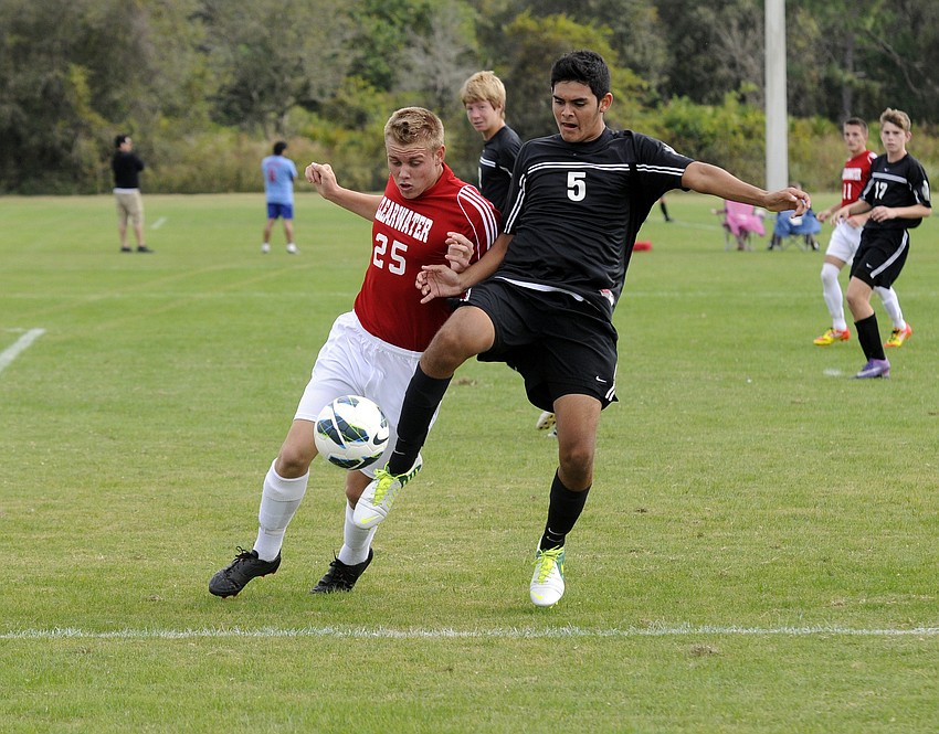 Braden Riverâ€™s Juan Morales battles a Clearwater defender for the ball.