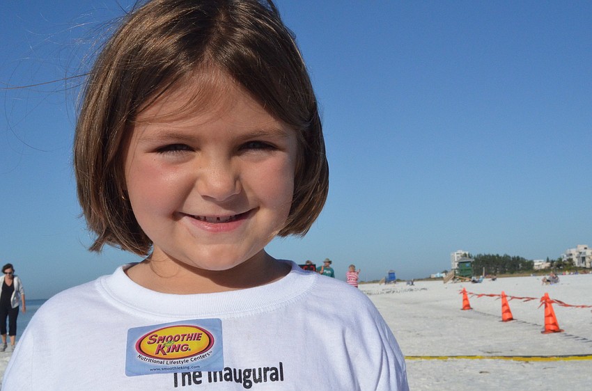 Grace Rogers cheers on the runners.