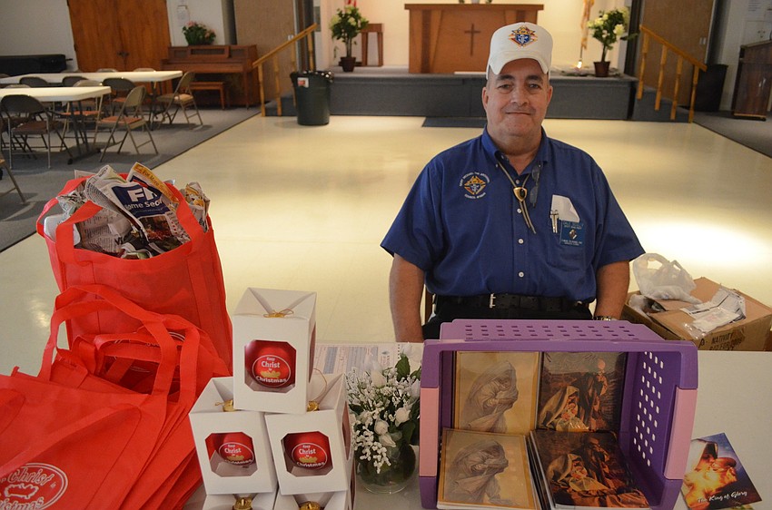 Deputy Grand Knight Dale Scully sells Christmas ornaments and decorations at the pancake breakfast.