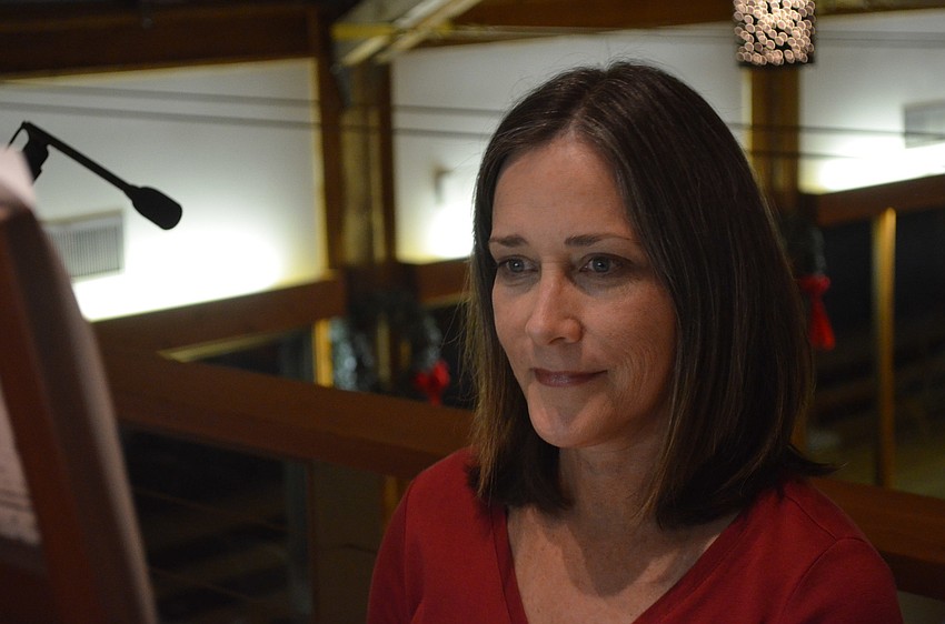 Director of Music Cynthis Roberts plays Christmas songs during the decorating of the Christmas tree.