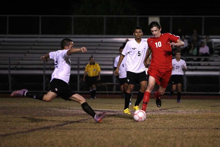 Bookerâ€™s Jose Cano, No. 2, goes to kick the ball away from Cardinal Mooneyâ€™s Greg Illig, No. 10, Tuesday, Dec. 4, at Booker High School.