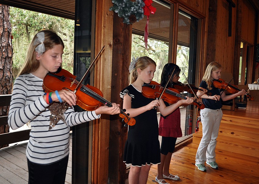 Shelby Fulton, Kaki France, SaGia Singh and Hayley Latta play their violins.