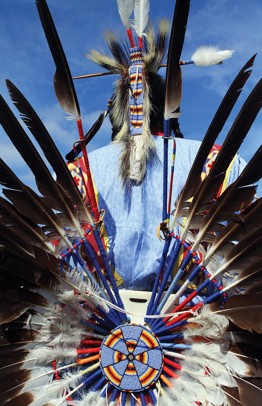 Duane Whitehorse displays the back of his ceremonial attire during the fifth annual Sarasota Indian Festival at the Sarasota Fairgrounds.