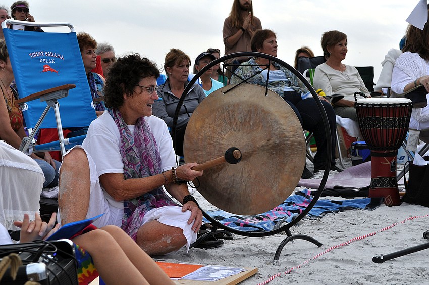 Patricia Cockerill sounding the gong between the elements and between each of the virtues that were read out loud around the mandala.