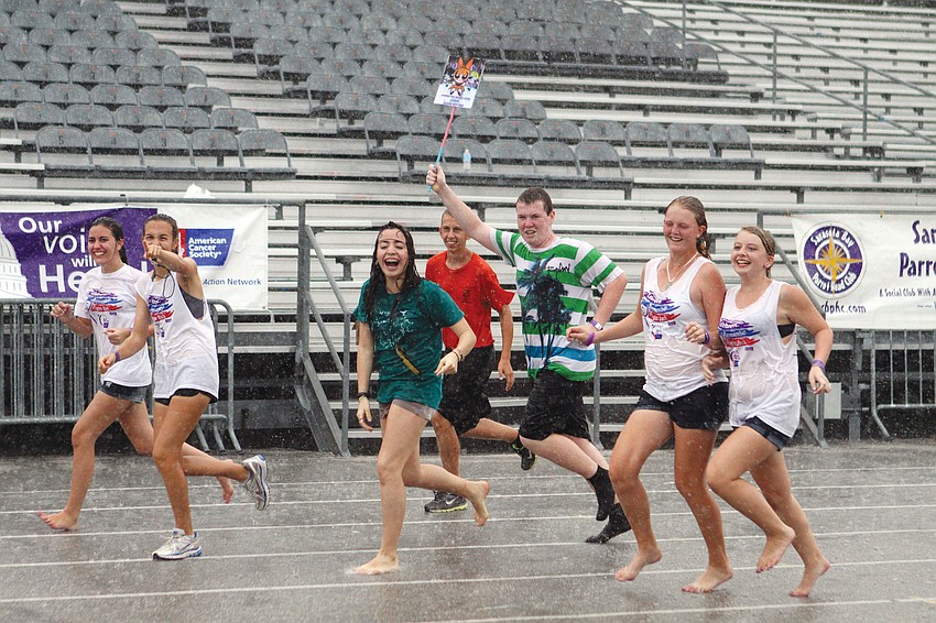 The Sarasota Teens With A Dream team continued to run their Relay for Life laps even during a downpour at Sarasota High School.