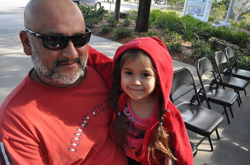 Yeraldo Funez and his daughter Paola wait to see his son Alex perform.