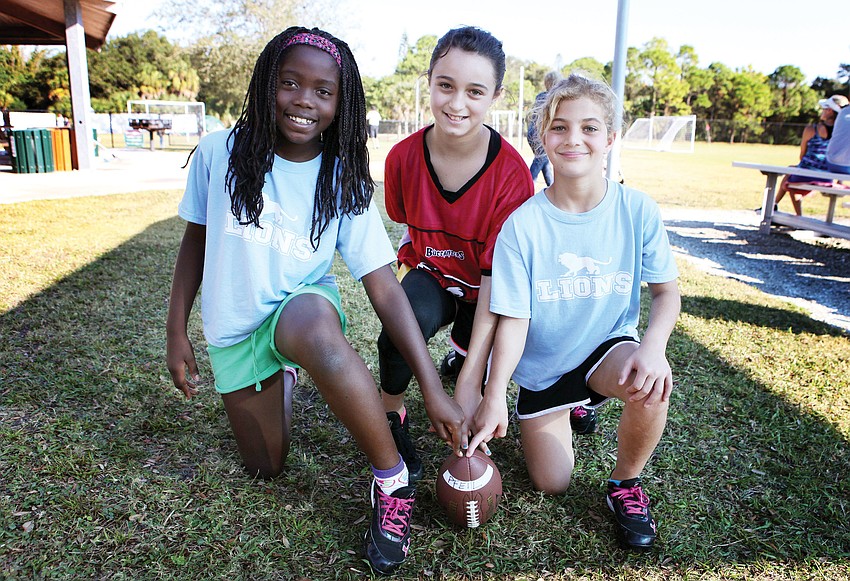 Bailey Saslow, 9, Chloe Delisle, 11, and Bianca Gruber, 9 1/2, pose together Saturday, Nov. 3, at Glebe Park. They are the only girls playing this season in the NFL flag football program that is offered through Suncoast Sports club at Glebe Park.
