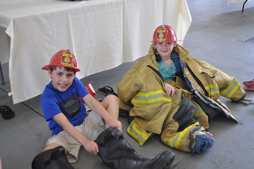 Michael Kretchmaner and his sister, Zoe, tried on firefighting gear March 31 at a Longboat Key Fire Department open house.