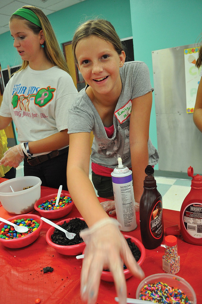 Braden River Middle School student Emily Manning adds sprinkles and other toppings to guestsâ€™ ice cream, during Tara Elementary's Ice Cream Social Sept. 7. Published Sept. 20, 2012.