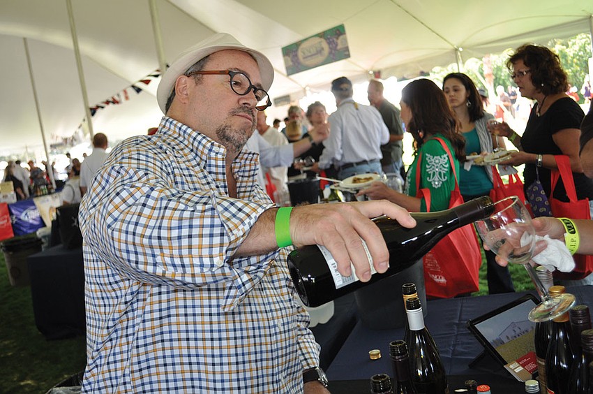 John Ireland pours samples from Pali Wine Co., during the Suncoast Food and Wine Festival Nov 10. Published Nov. 15, 2012.