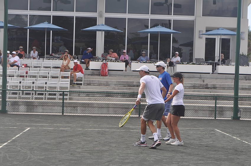 Mike Bryan, Jackie Bohannon and Bob Bryan hold hands while playing against rotating groups of doubles teams. The twin brothers have been ranked #1 in the world for more than 300 consecutive weeks, so the hand holding exercise served as a handicap.