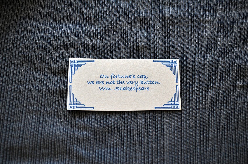 One of the many little pieces of paper set at each seat with a button saying printed on it.