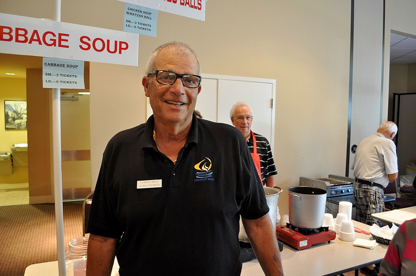 Alan Fishbein stands near the cabbage soup he cooked from his motherâ€™s recipe.
