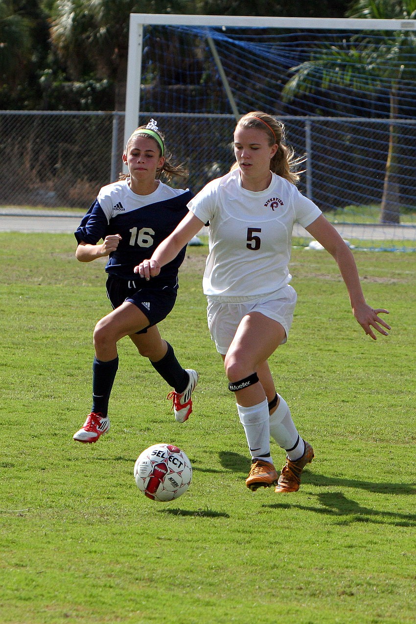 North Portâ€™s Alexis Egoville, No. 16, runs after Riverviewâ€™s Rachel Easterling, No. 5.