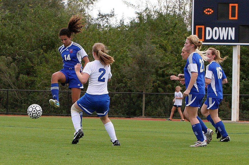 Northside Christianâ€™s Danielle Nashed, No. 14, jumps up high to get at the ball while Sarasota Christianâ€™s Hannah Youngblood, No. 2, tries to defend and get the ball back.