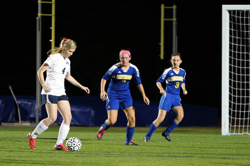 Out-of-Door Academyâ€™s Alli Gentile, No. 4, tries to keep the ball away from Canterbury Tuesday, Jan. 15, during the quarterfinal game between Out-of-Door Academy and Canterbury.