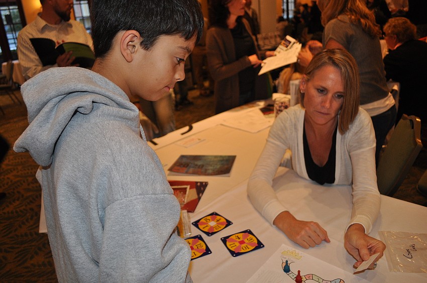 Brayan Dasilva played a math game with Jana Espy of the Calvary Chapel School in Sarasota.