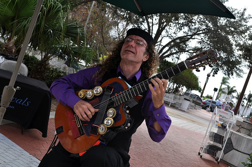 Russell Donnellon plays his guitar on the corner of Main and Gulfstream.