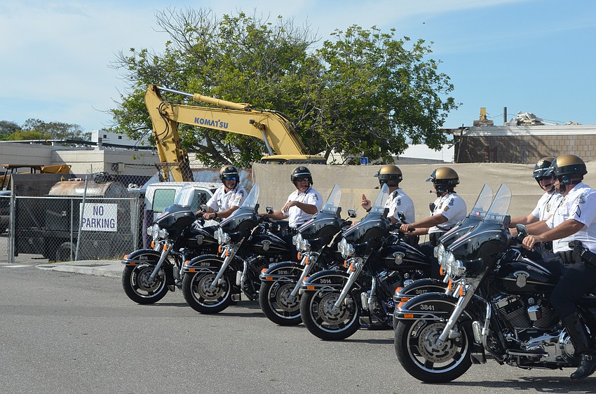 Police escorted the marchers from Booker High School to Dr. Martin Luther King Jr.  Park.