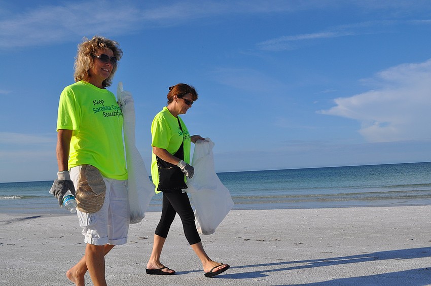Pam Marenghi and Maureen Gebhardt head north on Siesta Key beach during the Coastal Cleanup.