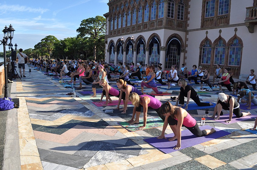 Students make their way into a lunging pose during the hour-long class Saturday, Sept. 15 at the Ca dâ€™Zan.