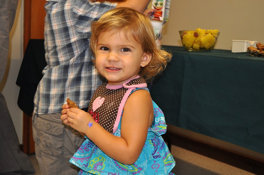 Polly Teffenhart, 1 Â½, smiles as she enjoys eating a chocolate chip cookie after ChapelKidz Sunday, Sept. 23.