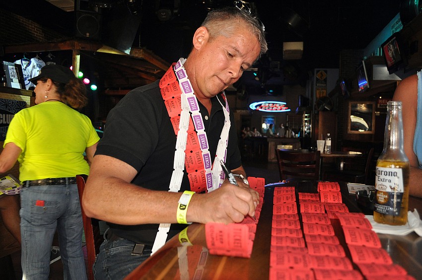 Bill Borgelt fills out his raffle tickets Thursday, Oct. 4 at Beach Club.