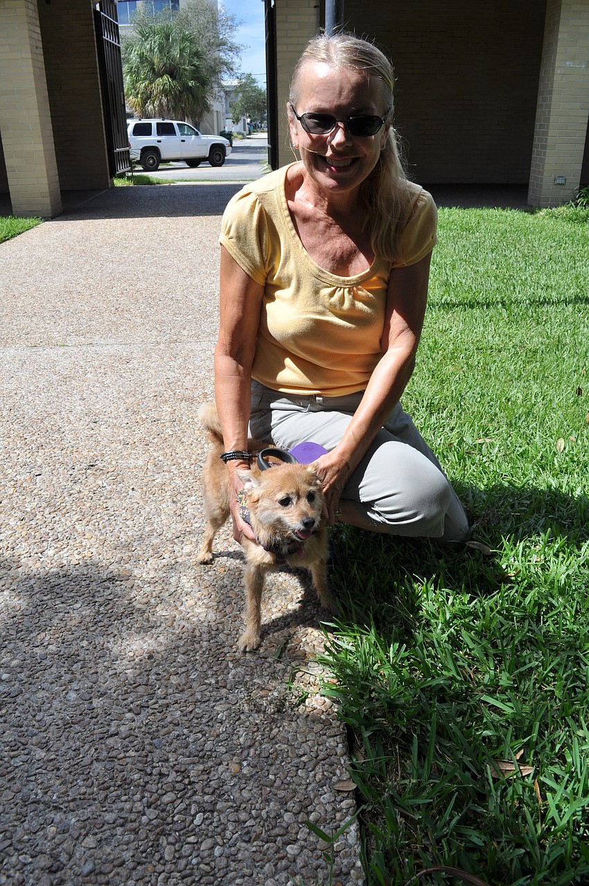 Gail Fegan crouches next to her dog, Mookie.