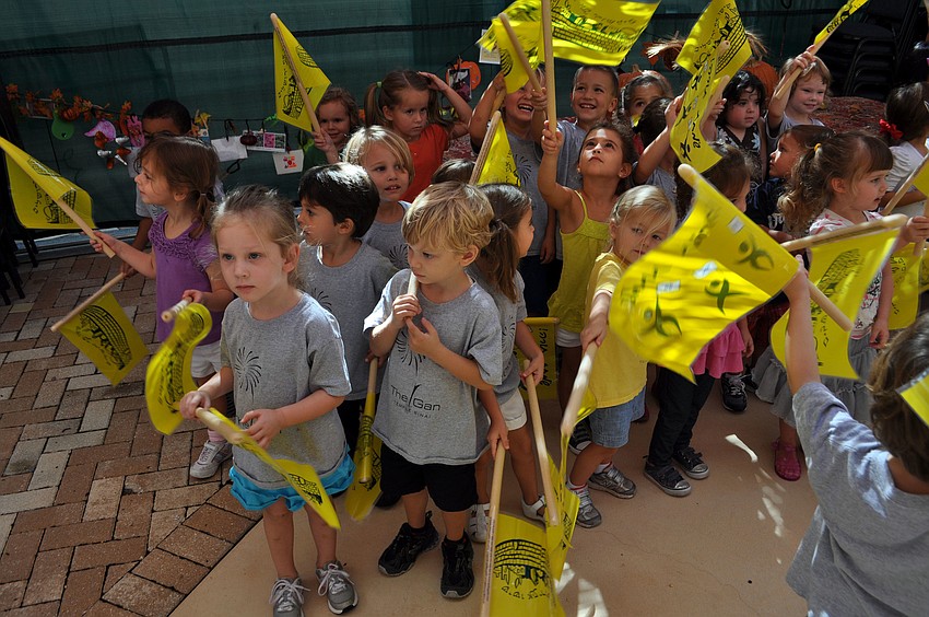 Children wave their flags in celebration.