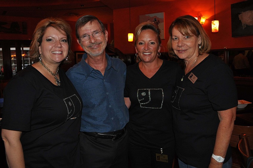 Goodwill Foundation Vice President Veronica Miller and Foundation President Bob Rosinksy with employees Kelly Gardner and Connie Aglin