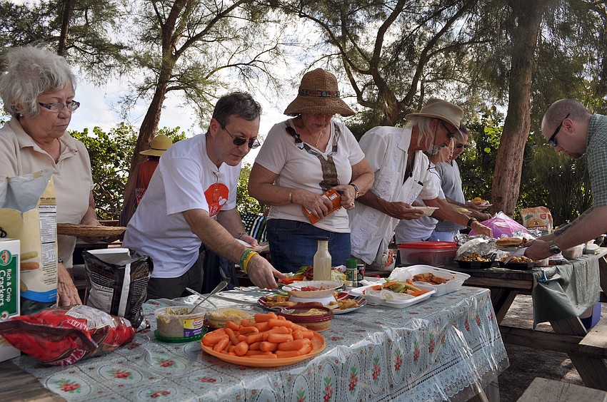 Those who attended the WSLR beach bash fill up their plates with food.
