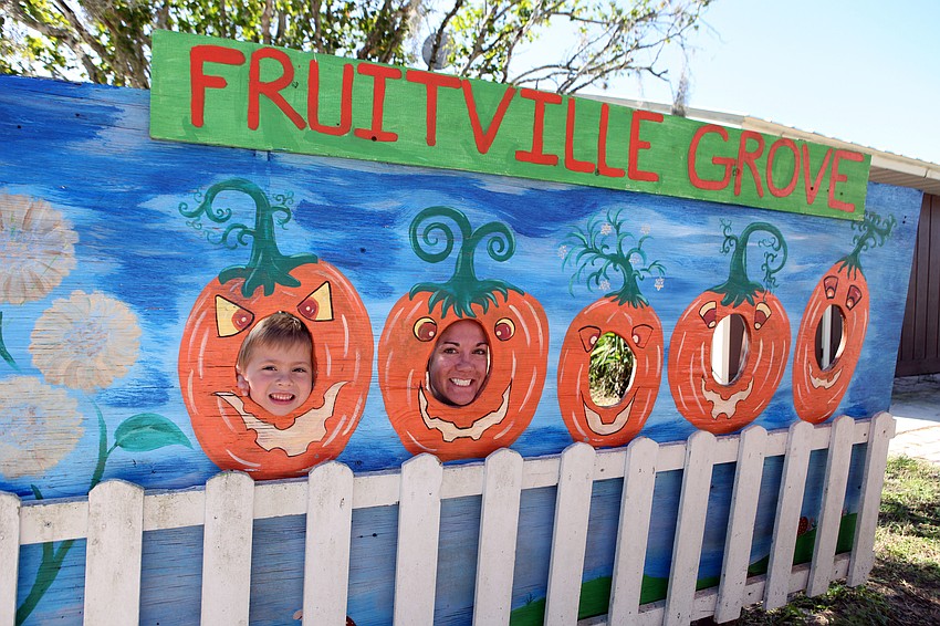 Will Emmons, 6, and his mom, Liz Kingsley, have fun being pumpkins in the Fruitville Grove pumpkin patch Saturday, Oct. 20.