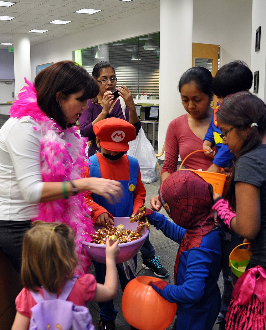 Melanie Hensey hands out candy during the trick-or-treating portion of the night at Selby Public Libraryâ€™s Halloween Party.