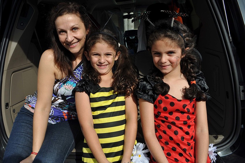 Dr. Dora Jarquin passed out candy her daughters, Kayla and Kiana Foroughi.