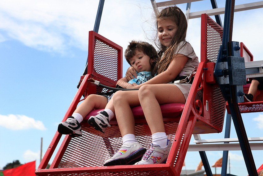 Nicholas, 3, and Tori, 7, Gordon ride the Ferris wheel together.