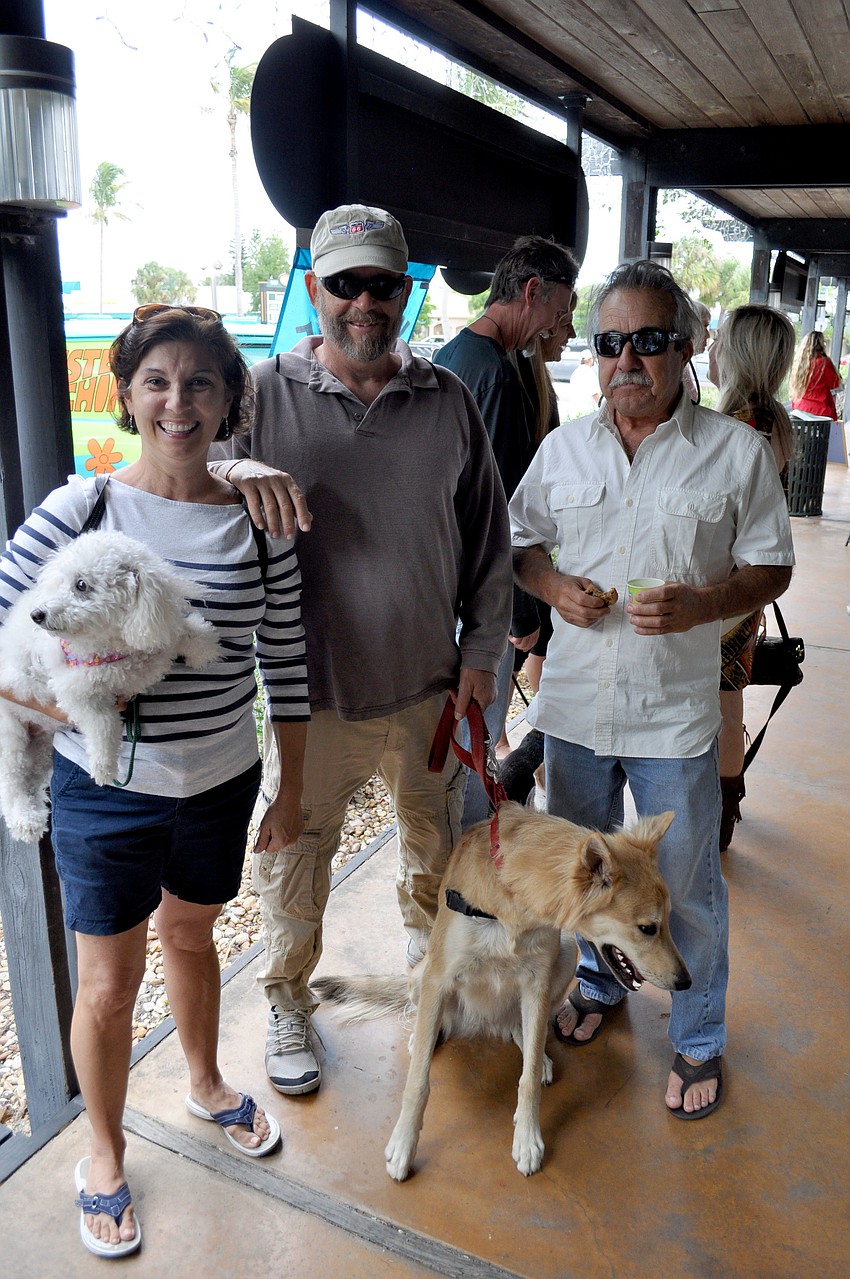 Lisa Grimes with her dog, Sophie, Greg Chapel with his dog, Bodie and Rick Pitts