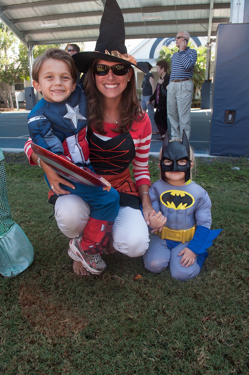 Preschool teacher leads Tristan and Cadin Bosek in the parade.