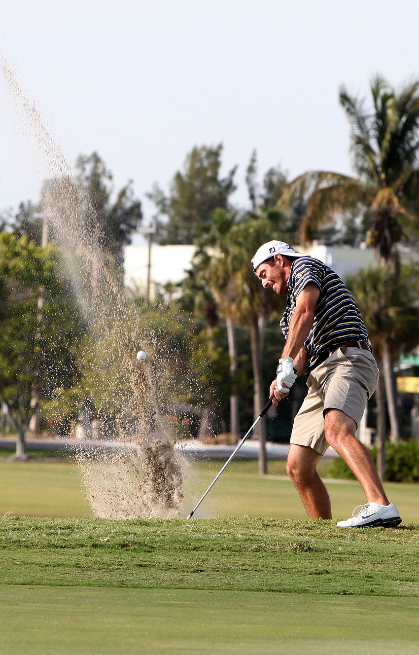 Mark Stevens hits his ball out of the sand trap on the 18th hole and up onto the green.