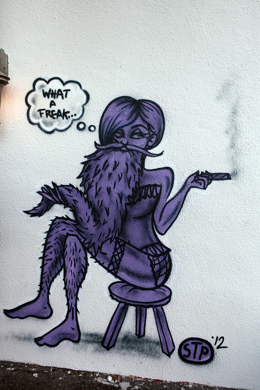 A vertical piece of a purple, bearded lady created by Stephen Palladino.