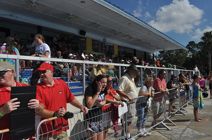 Fans cheer on their schools and their swimmers.