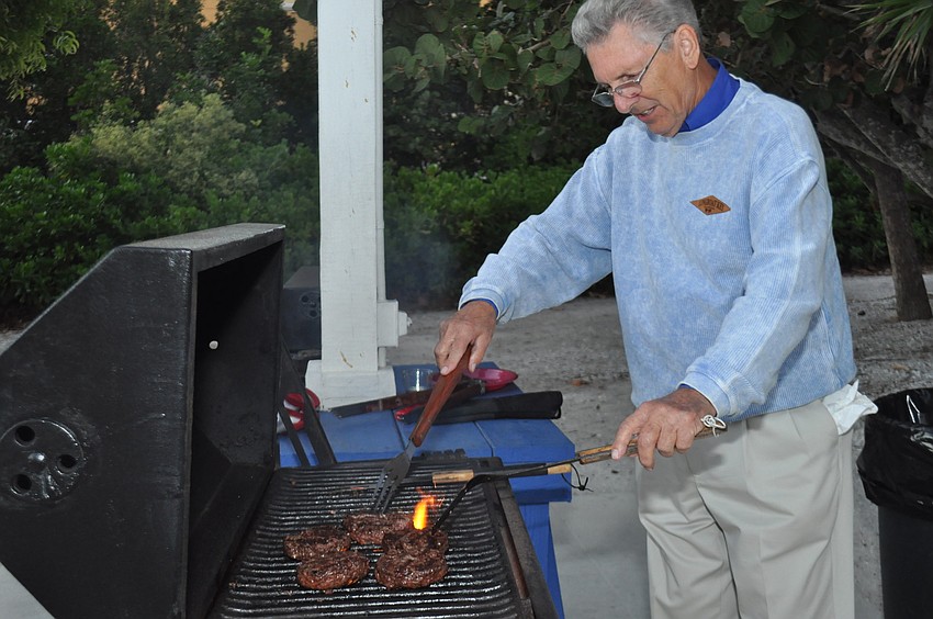 Ron Johnson grills burgers.