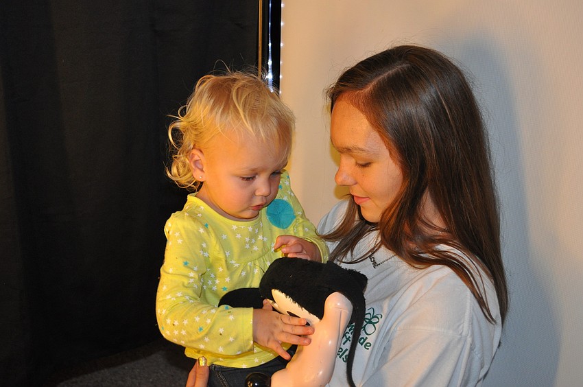 Katie Beiler held Kaylee Blanchard as they sat in a photo booth.