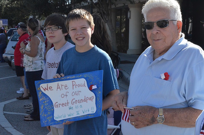 J.P. and Zachary Manning made a sign to recognize their great grandfather and WWII veteran John Mull.