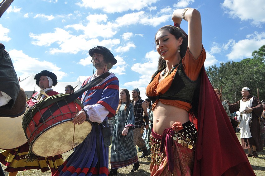 Belly dancer Angela Hicks parades with the other actors.