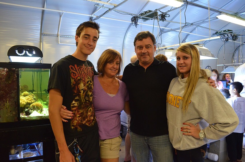 Jamie, Julie, James and Katie Kleinkopf. James donated the tank behind them to the high school.