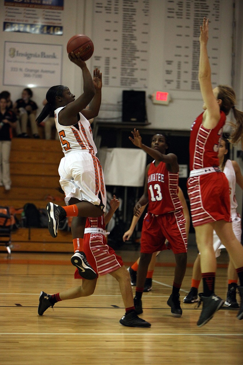 Zharia Grable, No. 15, shoots the ball and scores another point for Sarasota.