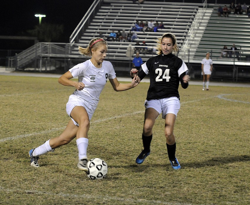 Lakewood Ranch defender Amanda Baar attempts to maneuver the ball past Braden Riverâ€™s Courtney Hart.
