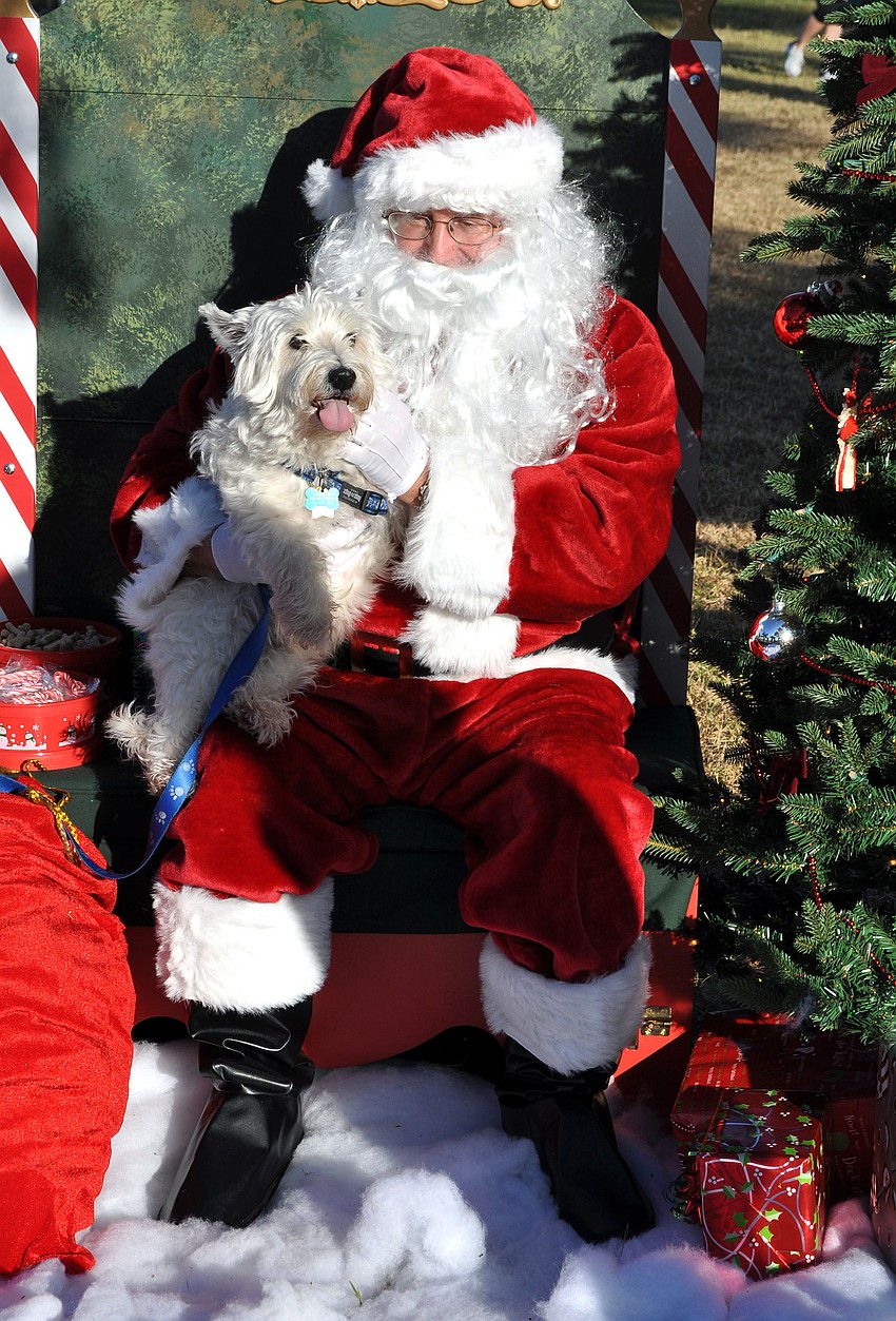 Chumsley, 11, smiles and sticks his tongue out while sitting with Santa Saturday, Dec. 1, at Payne Park.