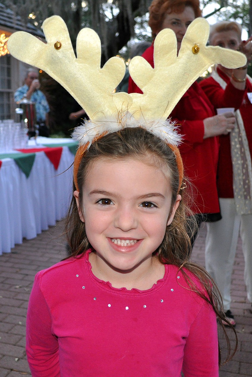 Lucie Perales, 5, wore reindeer antlers to the lighting of the bromeliad tree.